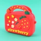 کیف هندزفری سیلیکونی بنددار چمدانی Strawberry